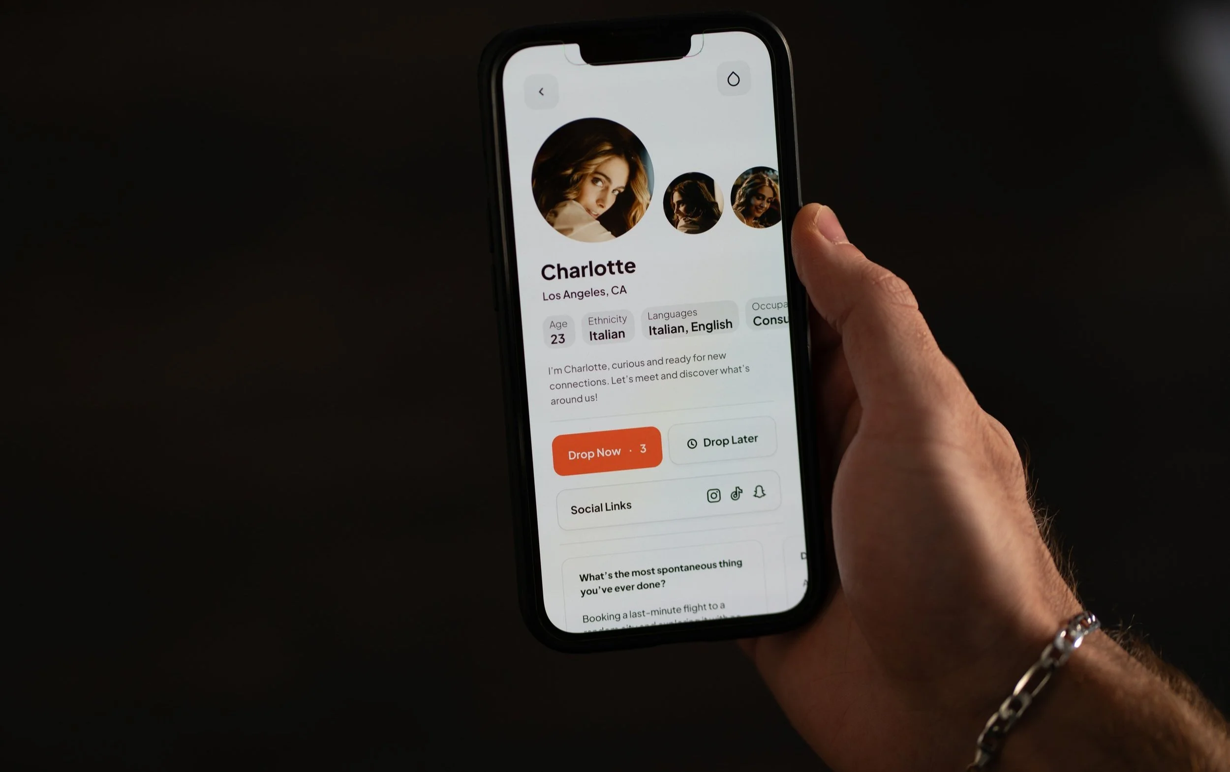 Drop Socials app profile screen held in a hand